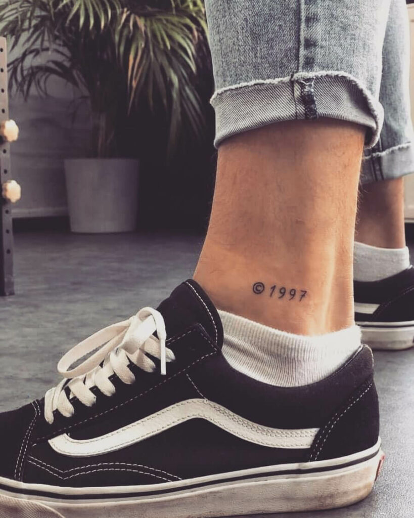 1997 lettering tattoo on the achilles