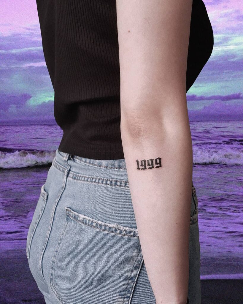 1999 lettering tattoo located on the wrist