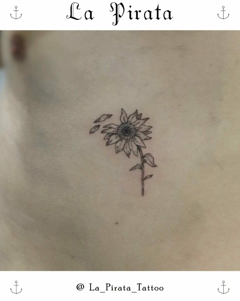 Tiny daisy tattoo on the ankle