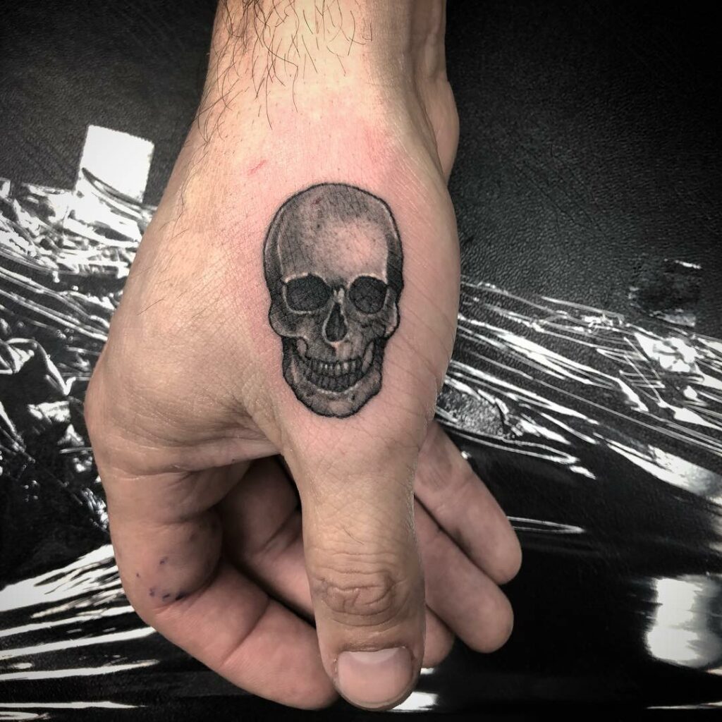 Minimalist Skeleton Face Hand Tattoo