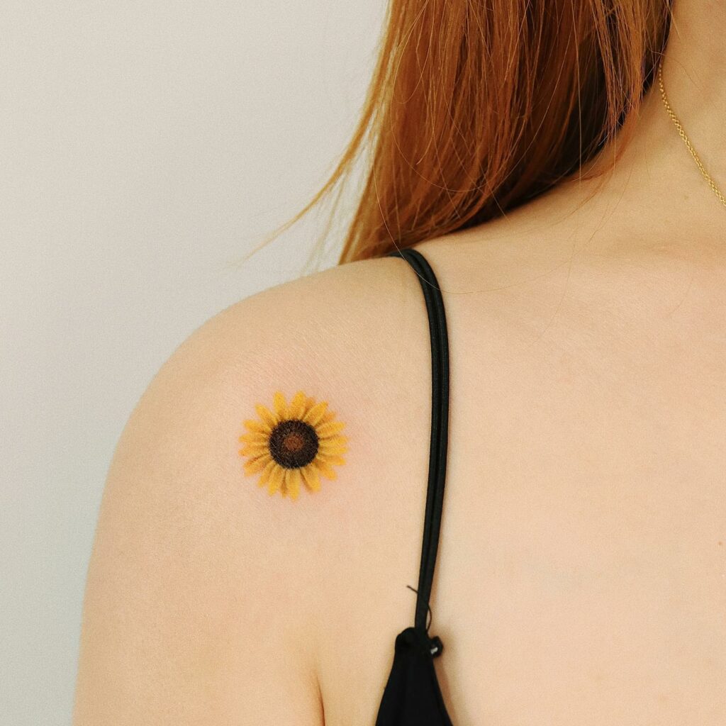 Watercolor sunflower tattoo on the right shoulder