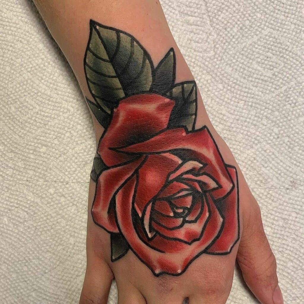 Hand holding a rose tattoo on the right inner forearm  Traditional hand  tattoo Hand holding tattoo Hand tattoos