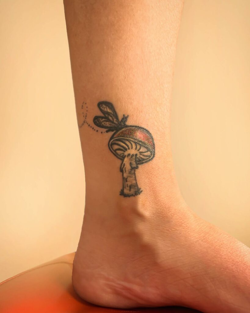 Psychedelic mushroom tattoo on the inner arm
