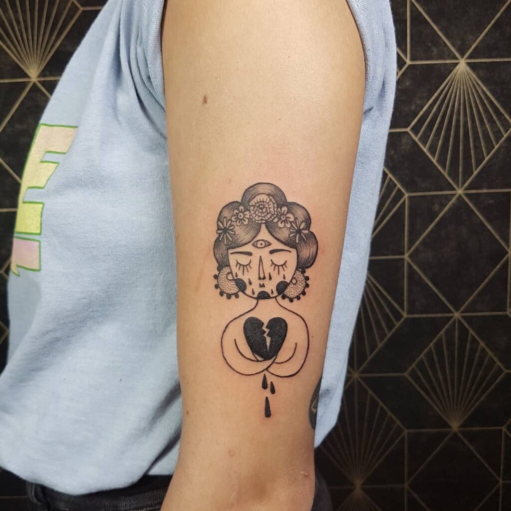 Happy and sad lettering tattoo on ankle