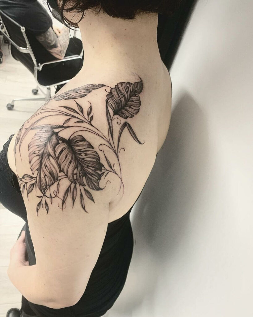 Hand poked monstera leaves tattooed on the forearm