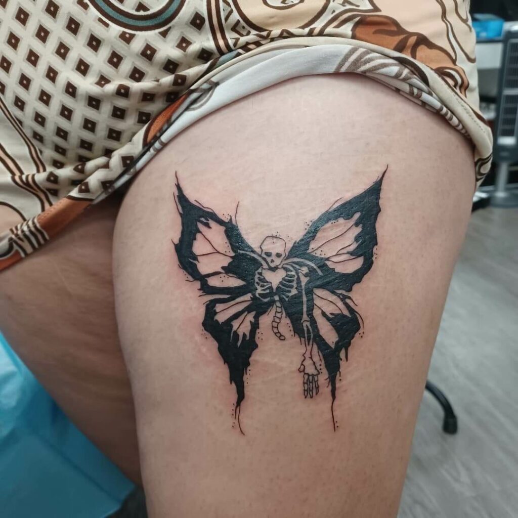 black skull butterfly tattoo on foot