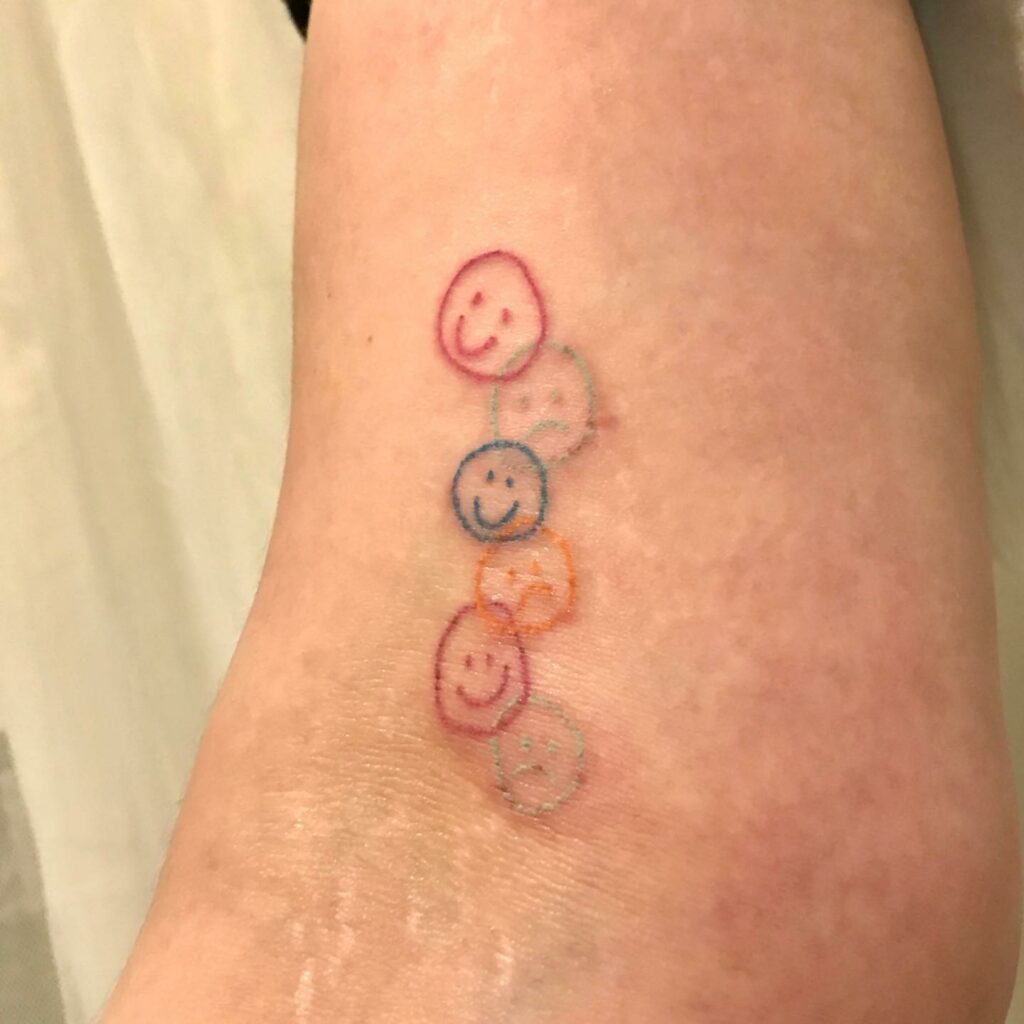 Tattoo Of Group Of Smiley Faces On Arms