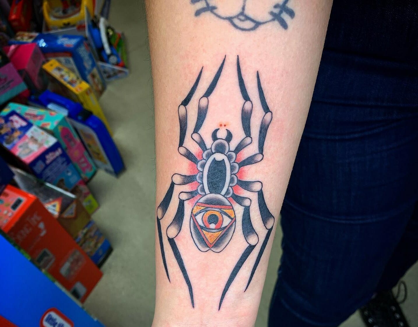 Fine line black widow spider tattoo on the hand