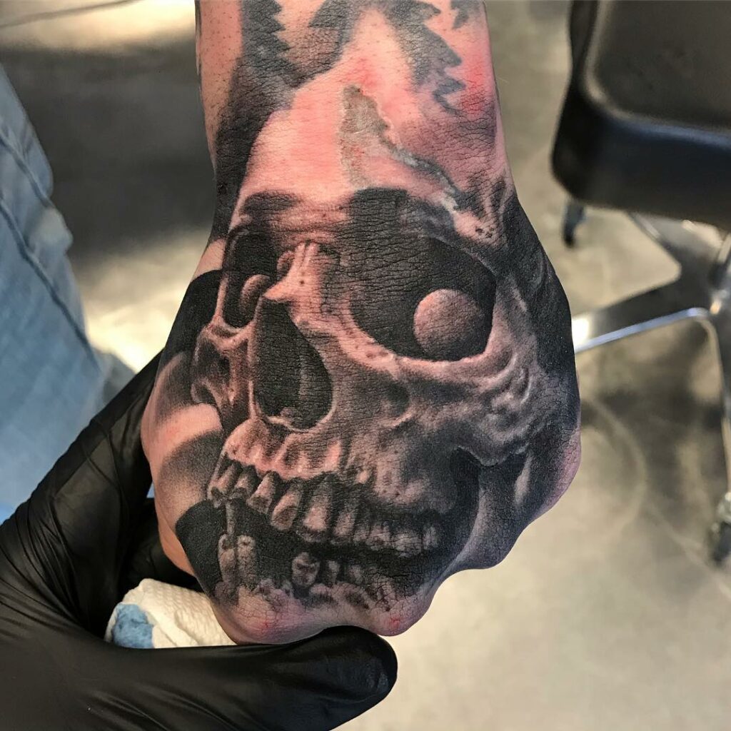 Traditional Skeleton Face Hand Tattoo