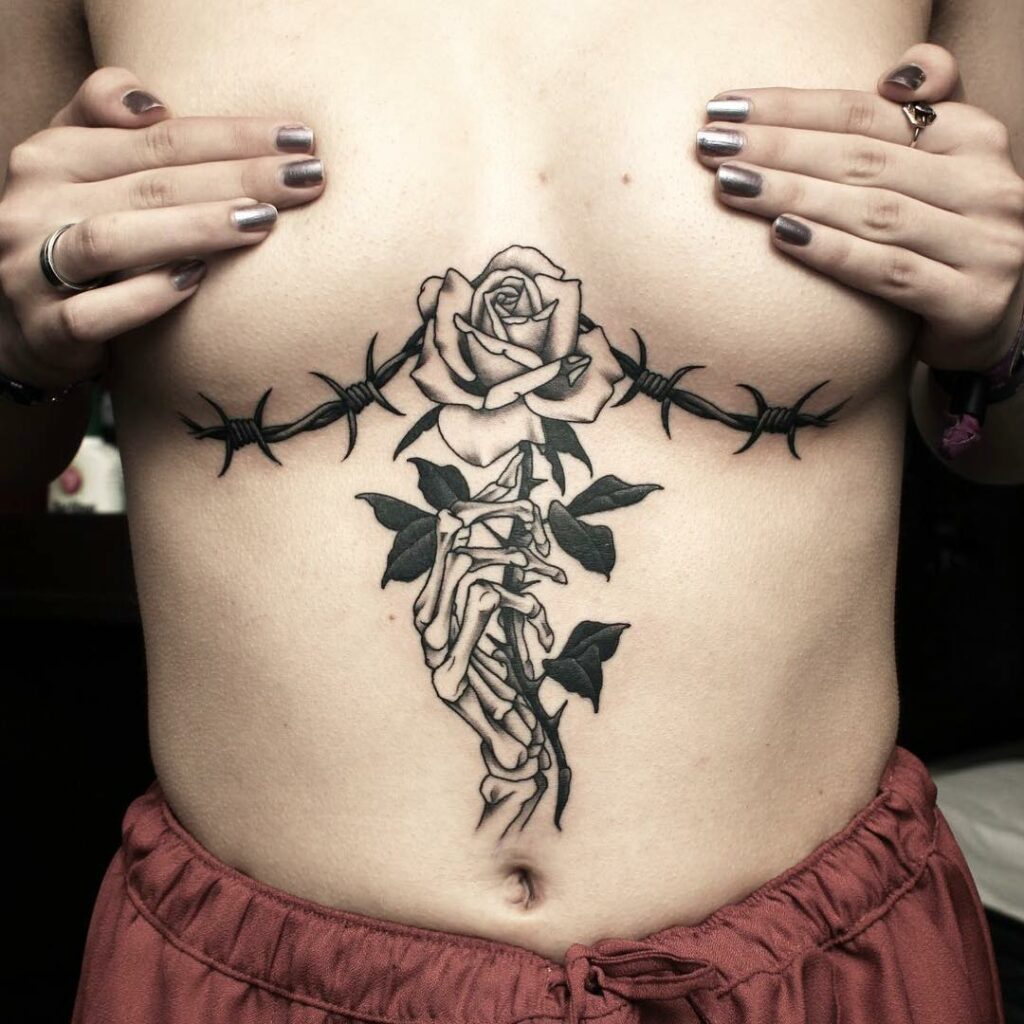 Under The Chest Rose Stem Tattoo Designs