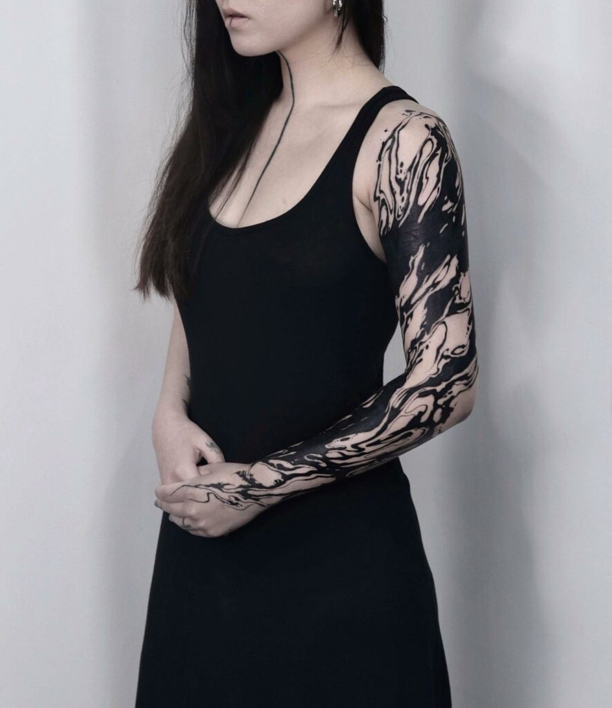 Woman Back Of Arm Tattoo