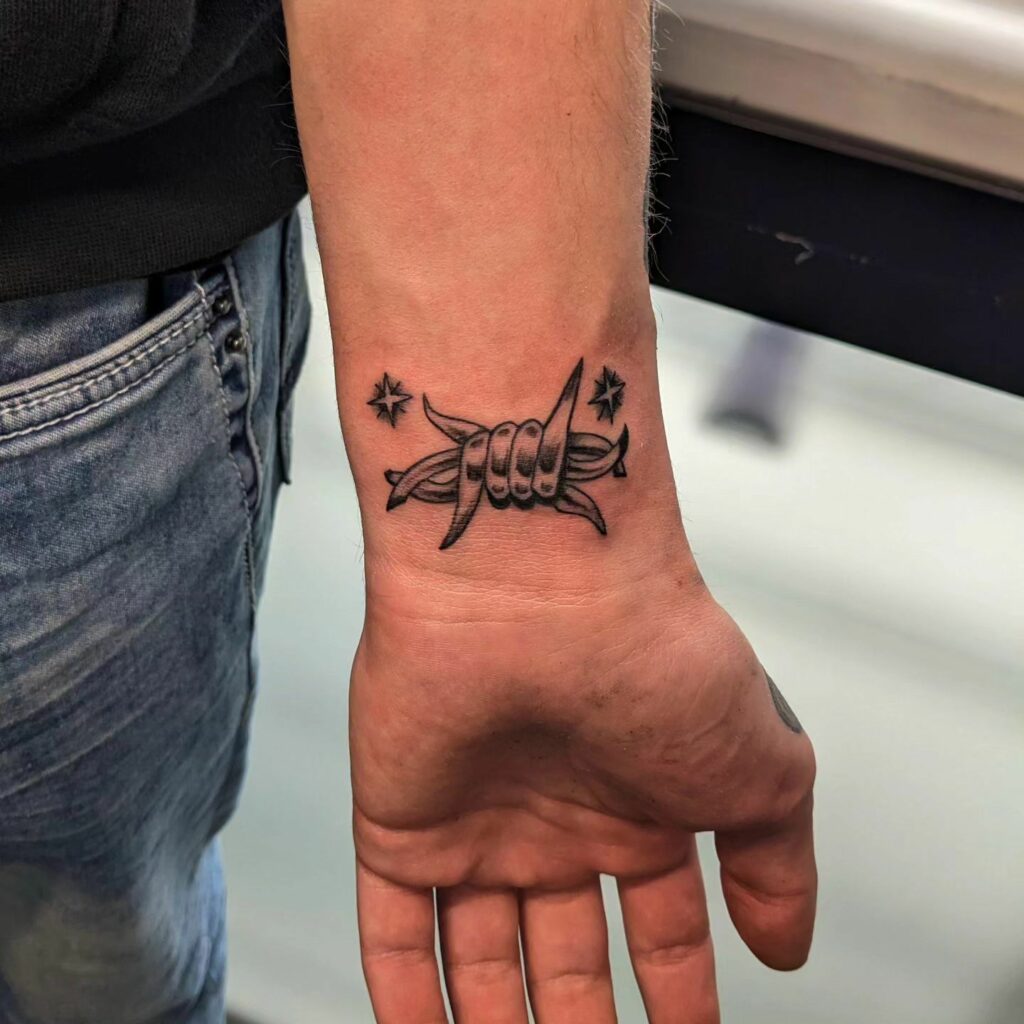 Barbed wire on wrist tattoo 