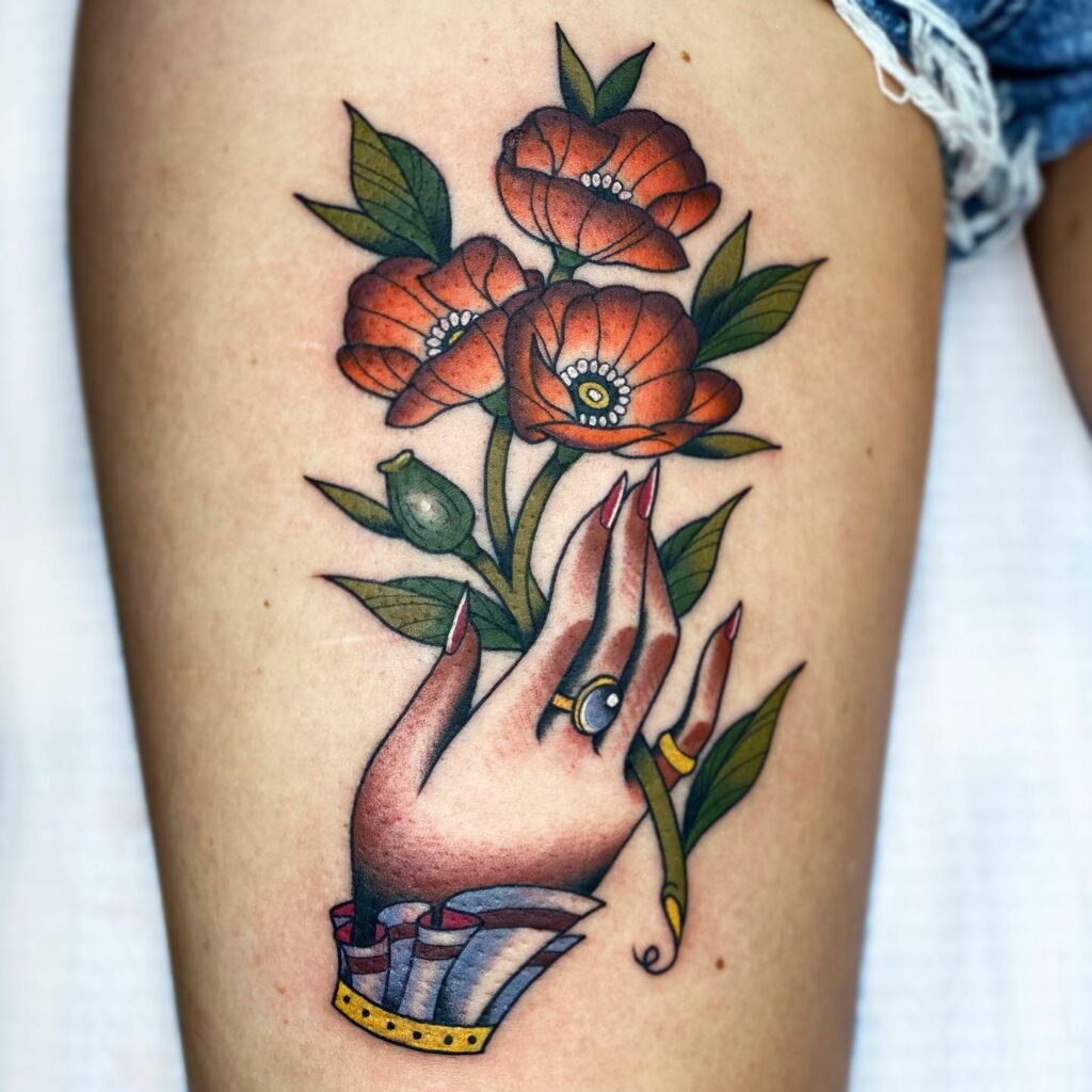 Hand Holding A Poppy Tattoo
