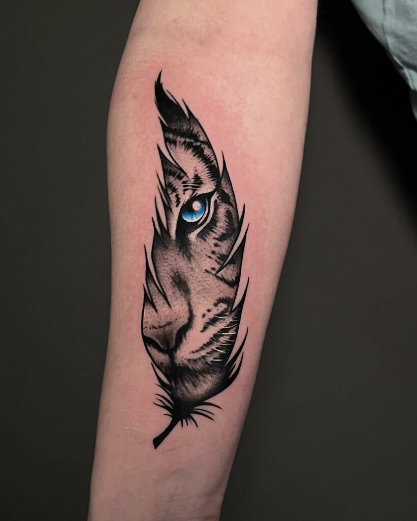 Enchanting Feather Tattoo: Eye of a Bird within Delicate Wings