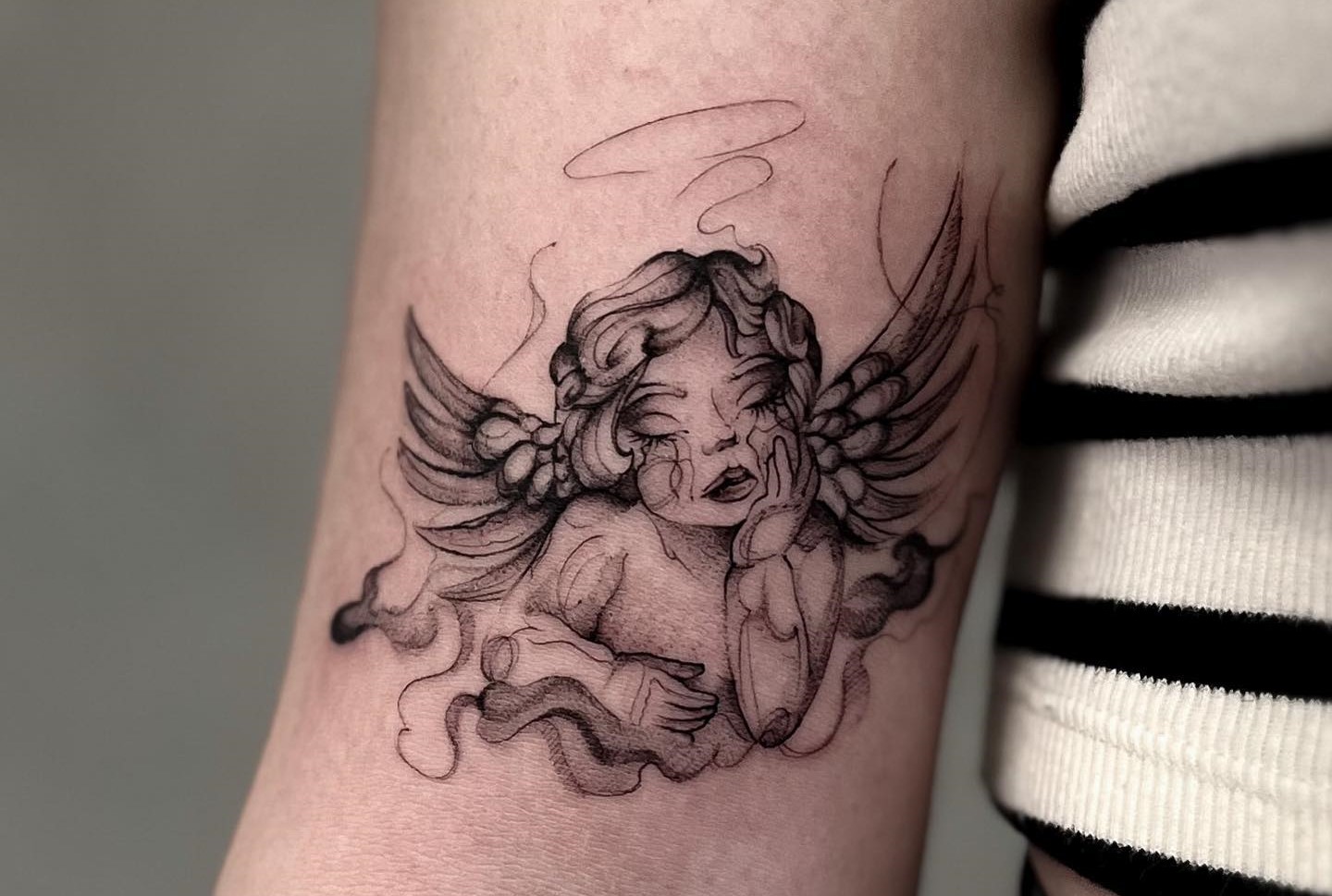 Baby angel tattoo meaning