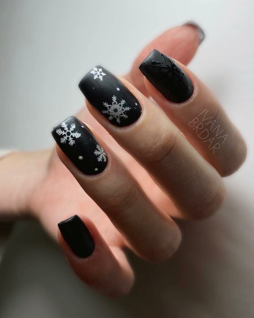 Snowflake-Adorned Black & White Nails