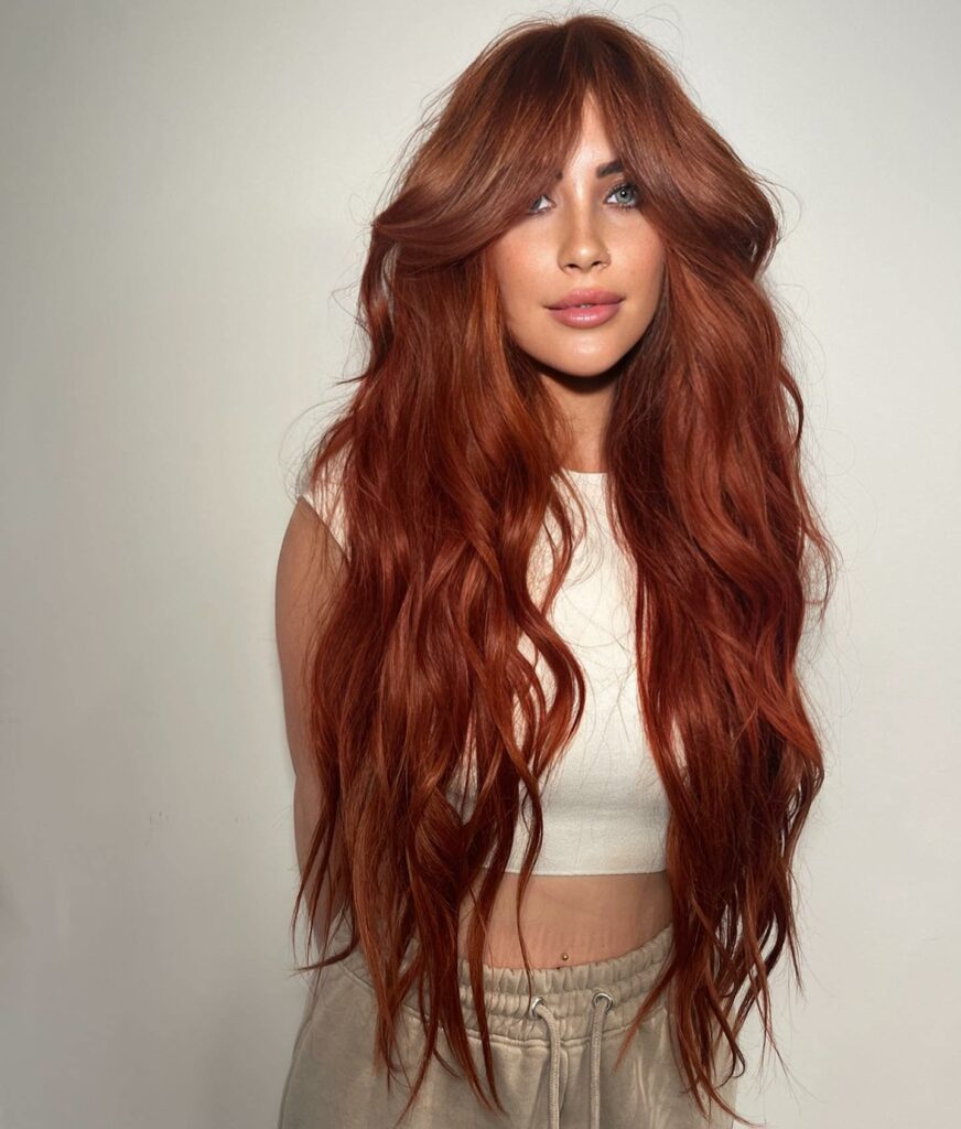 Long Red Hair with Layers and Curtain Bangs