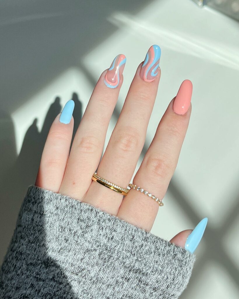 Light Blue And Peach Swirl Nail Design
