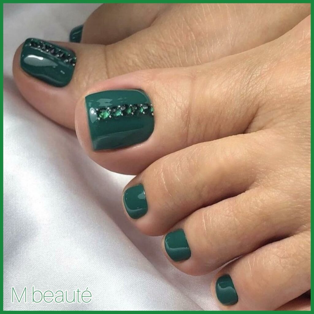 Dark Green Pedicure Adorned with Gems