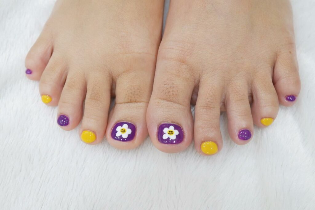 Yellow and Purple Pedicure with Smiley Daisies