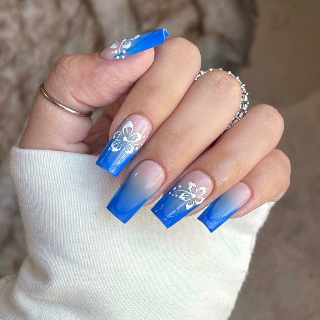 Intricate Floral Patterns on Classic Blue Nails