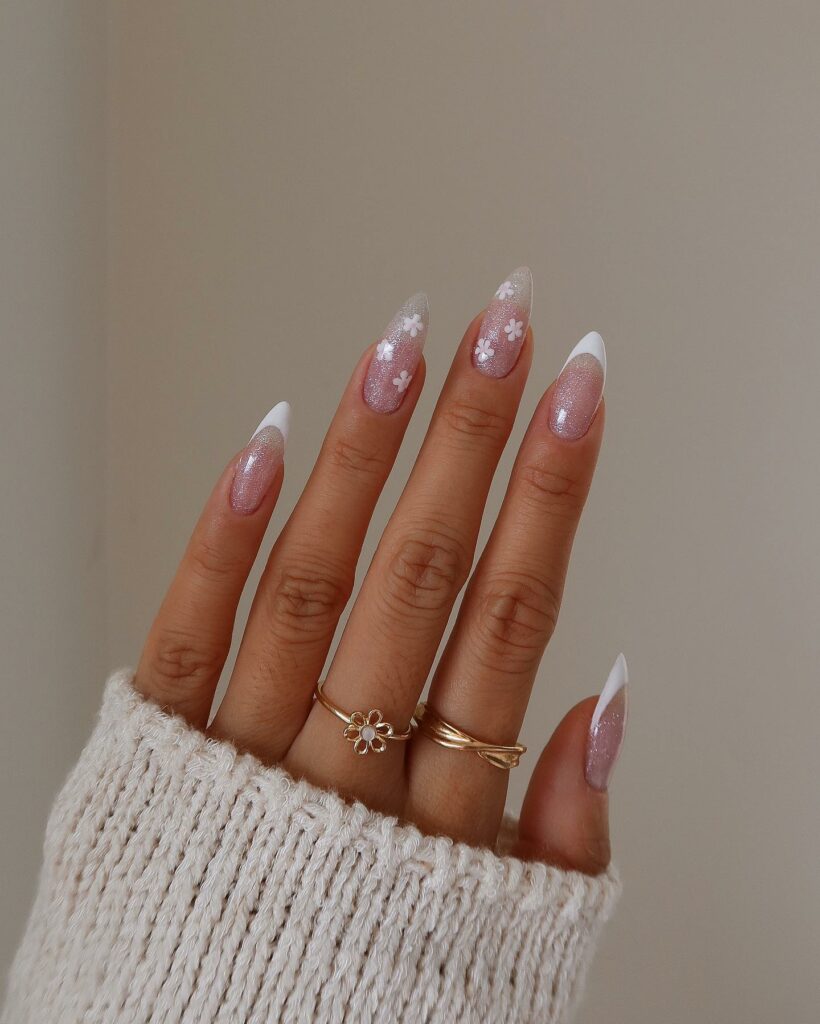 Glitter Nails Adorned with Delicate Floral Accents