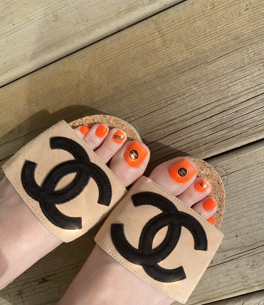 Orange Pedicure With ' Chanel ' Design