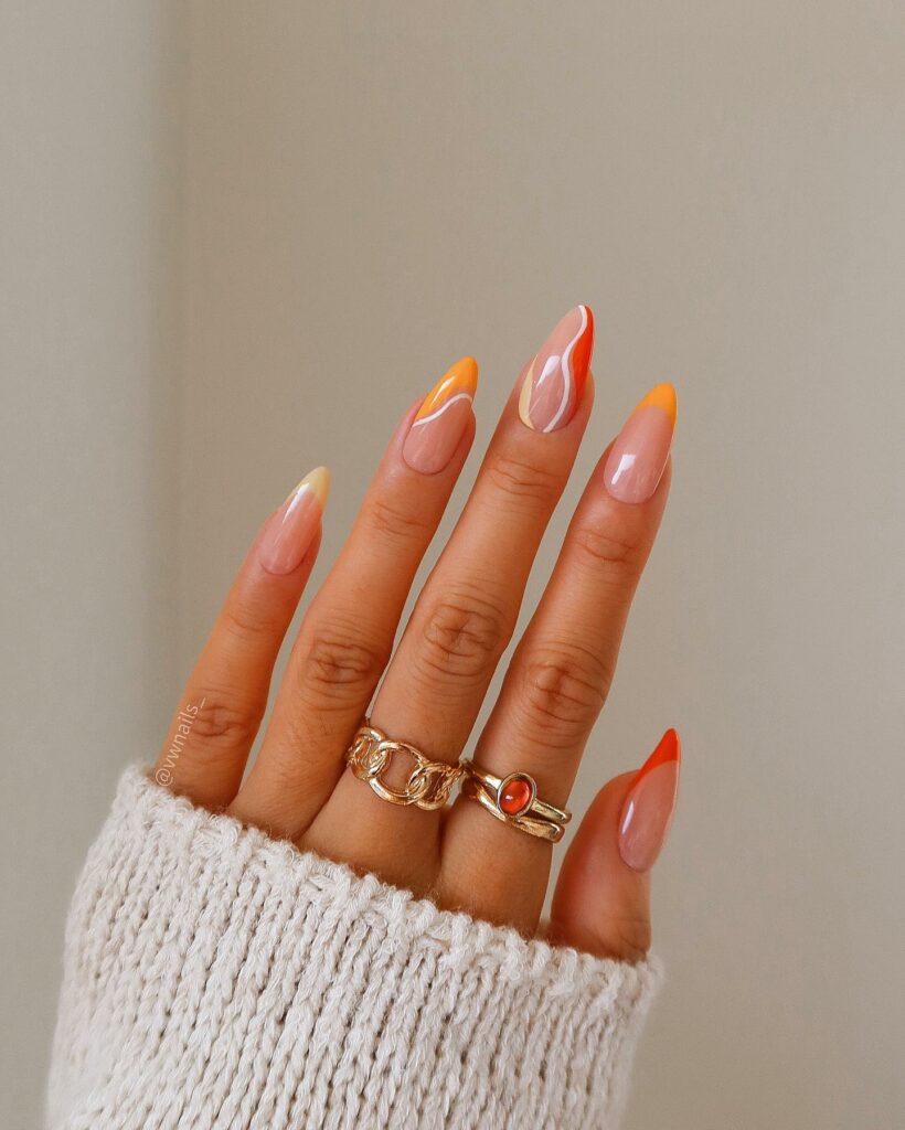 Abstract Orange French Tip Nails With Swirl