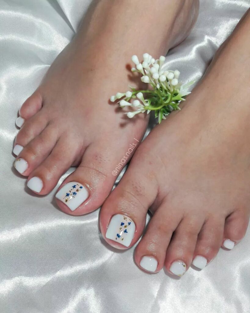Milky White Pedicure With Blue Flowers Design