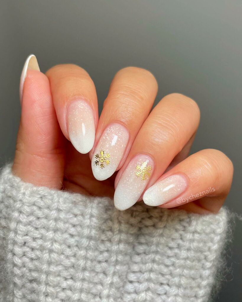 Winter Almond Nails With Gold Snow Flakes Design