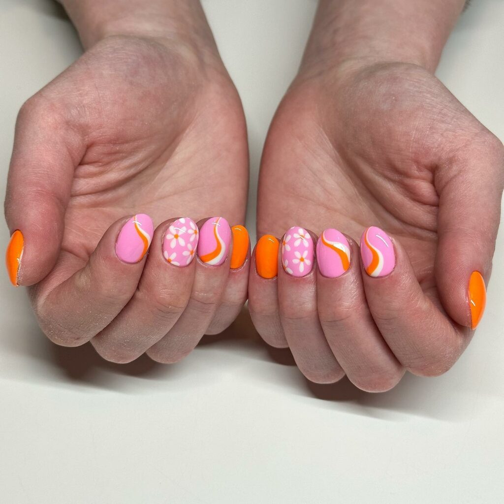 Pink And Orange Nails With Swirls And Flowers