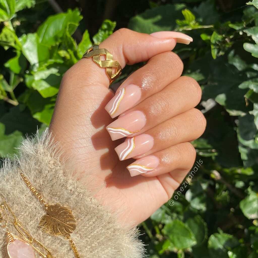 Nude And White Swirl Nails With Gold Glitters