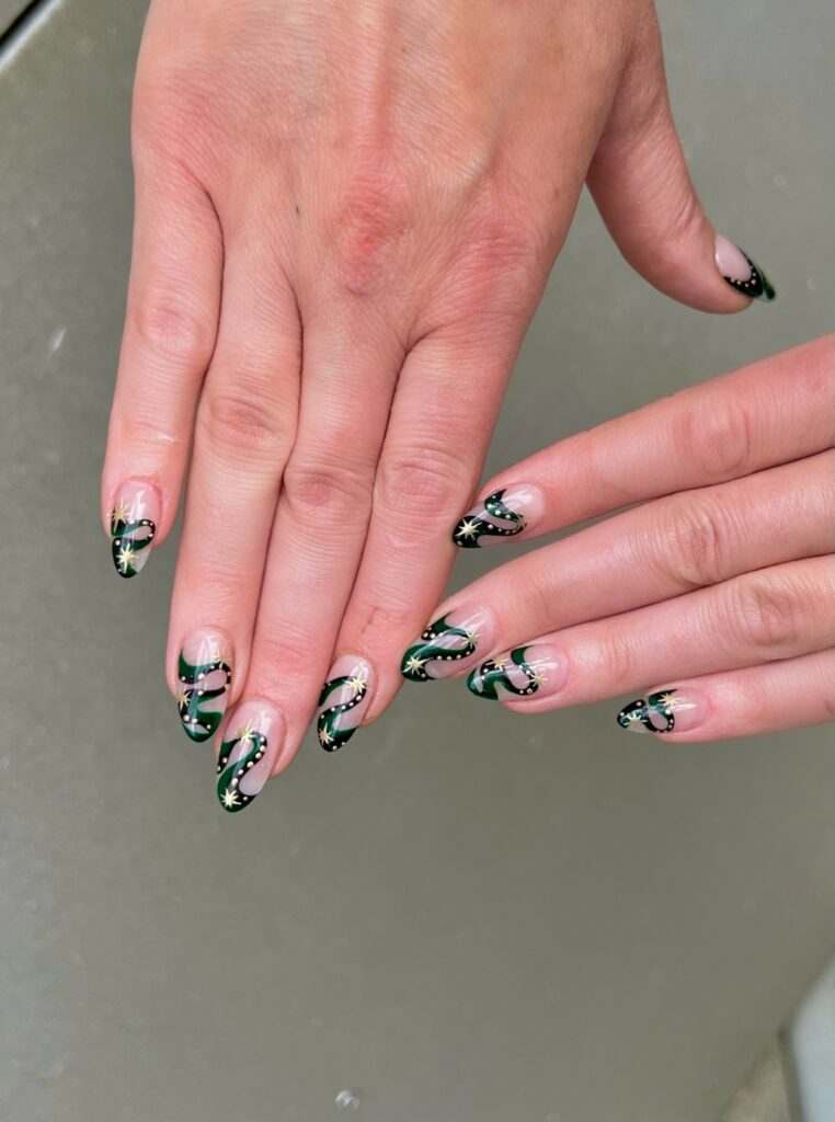 Green And Black Swirl Nails With Gold Glitters