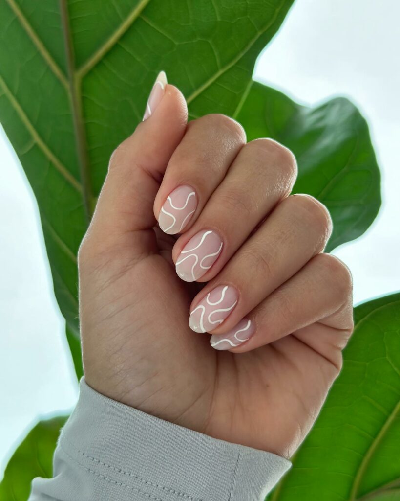 Matte Nude And White Swirl Nails