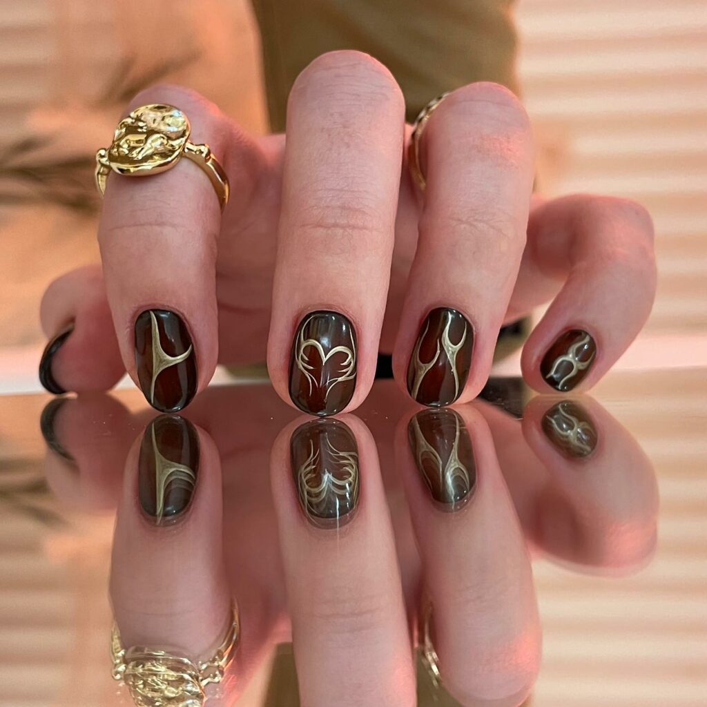 Abstract Burgundy and Gold Nails
