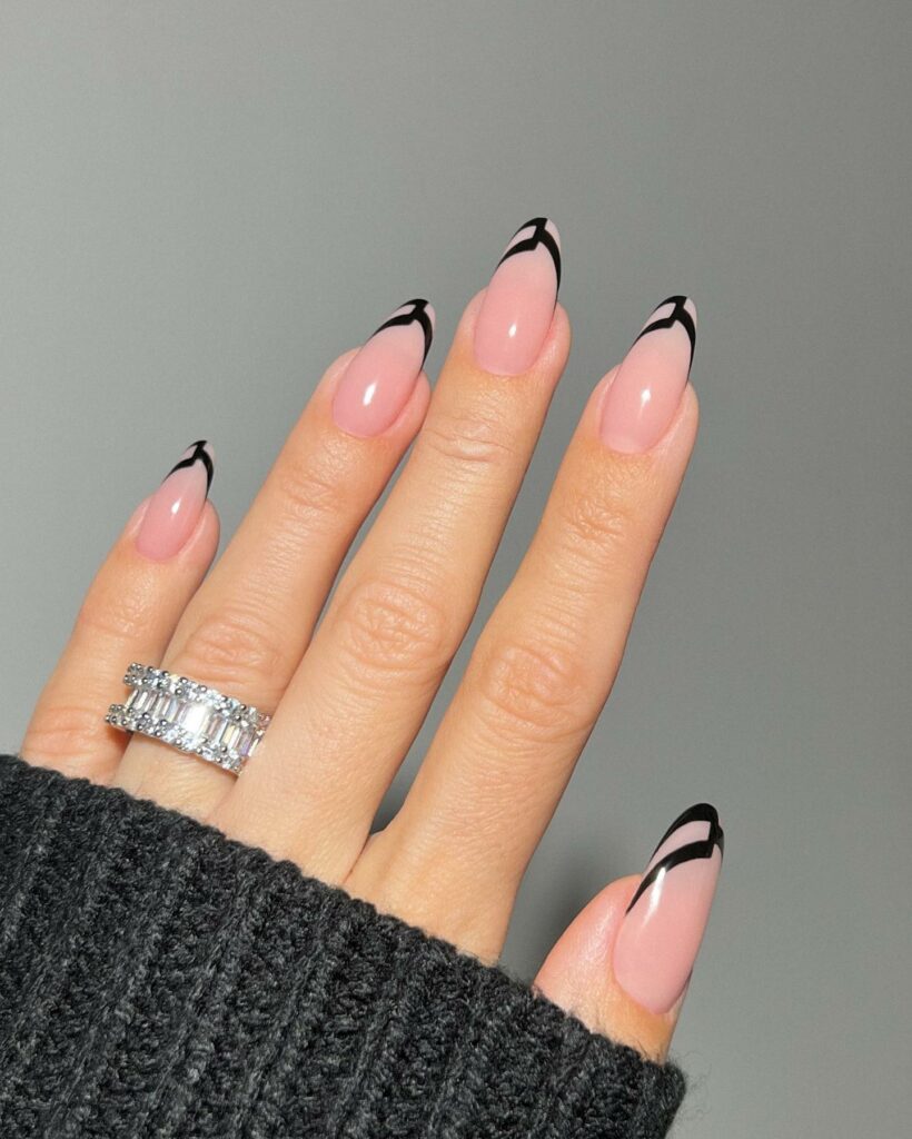 Avant-Garde Black Tips on Nude Almond Nails
