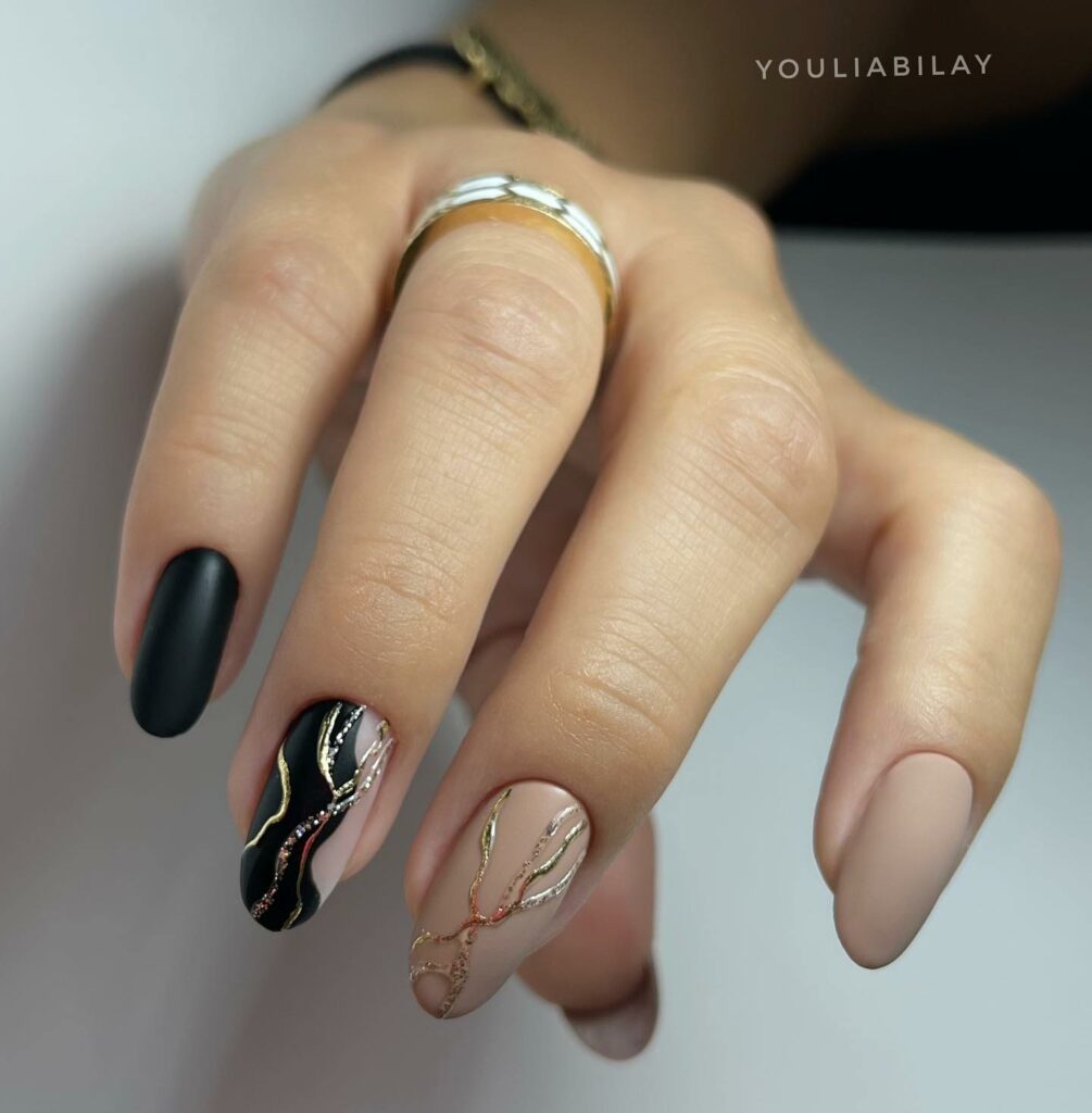 Black and Nude Nail Art with Metallic Accents