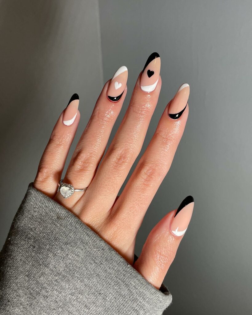 Heartfelt Black and Nude Nail Designs with a Modern Twist