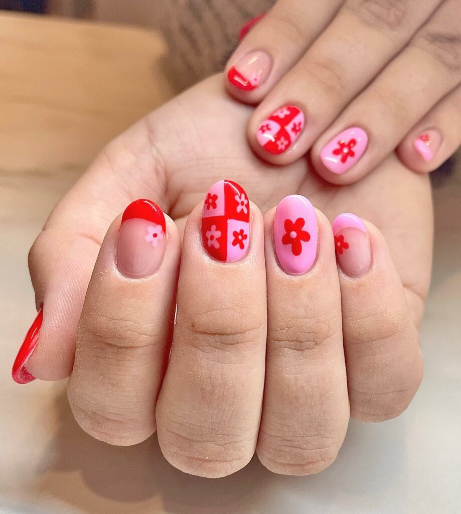 Red And Pink Nails with Floral Embellishments