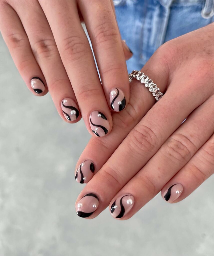 Short Black French Nails with Pearlescent Swirl Accents