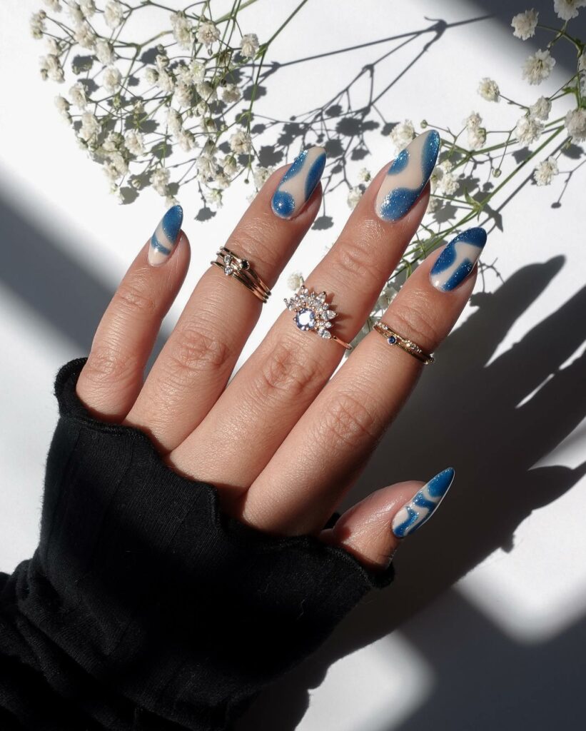 Negative Space Blue Almond Nails With Glitter