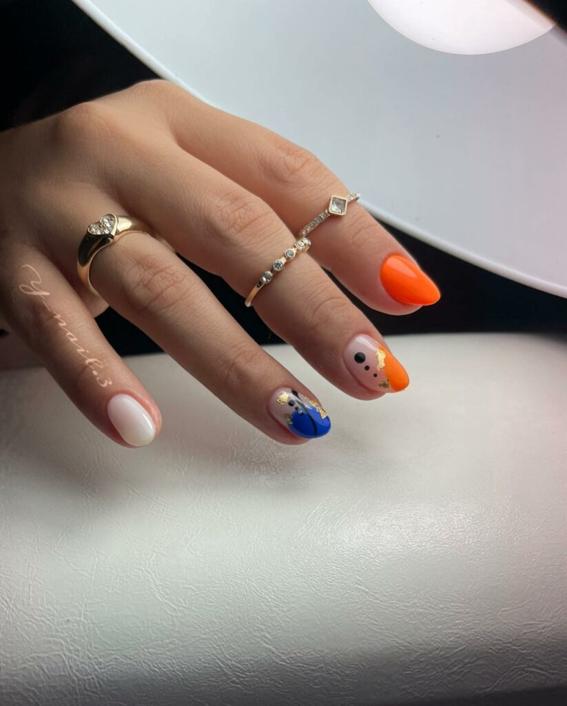 Orange And Blue Nails With Gold Flakes
