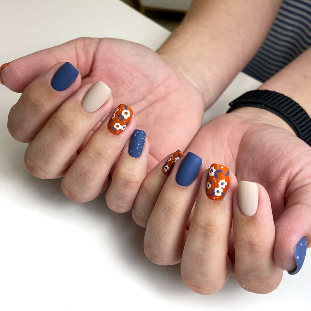 Orange And Blue Matte Nails With Daisy Flower Design
