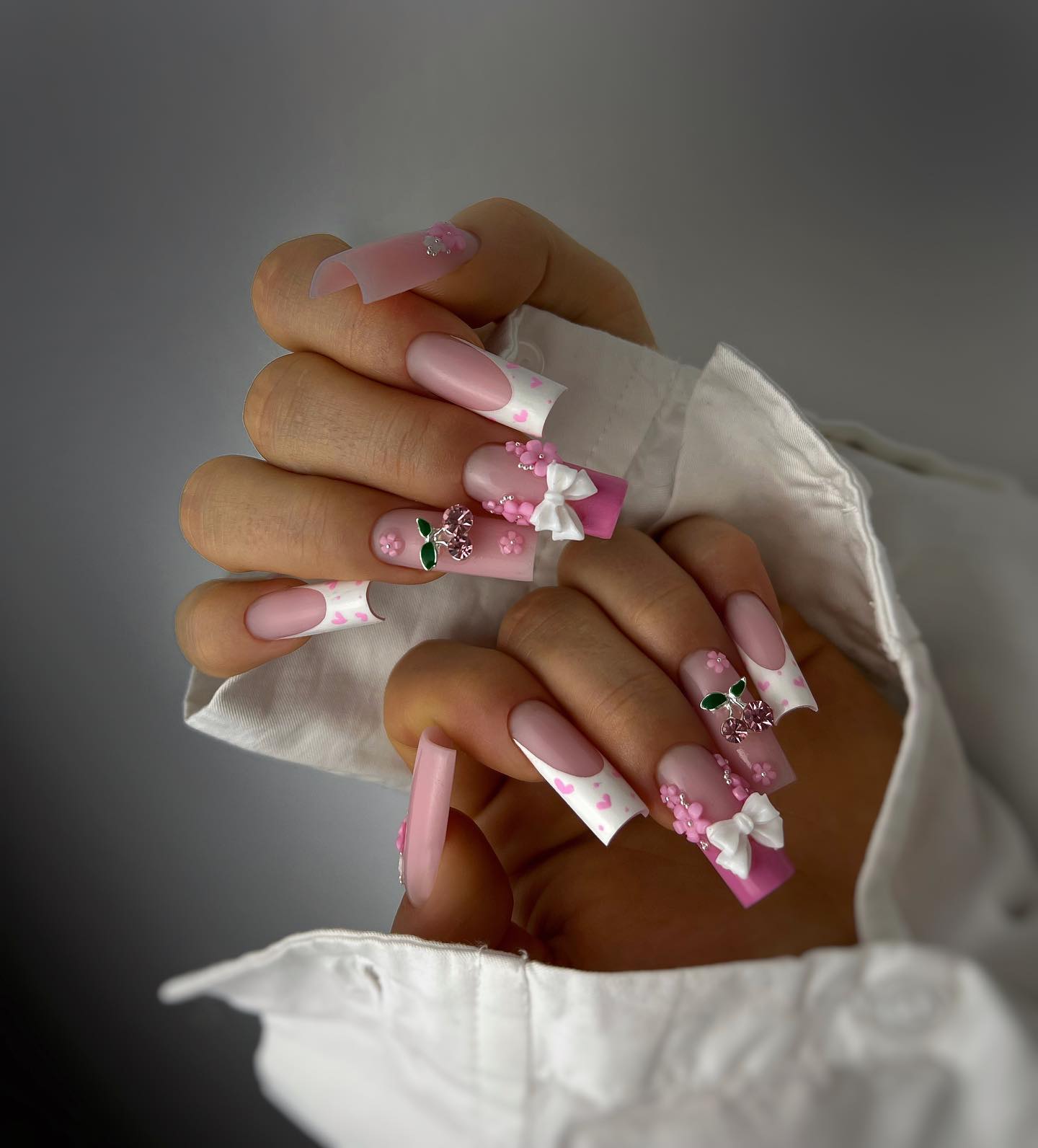Chic Pink and White Floral Nail Art with 3D Accents