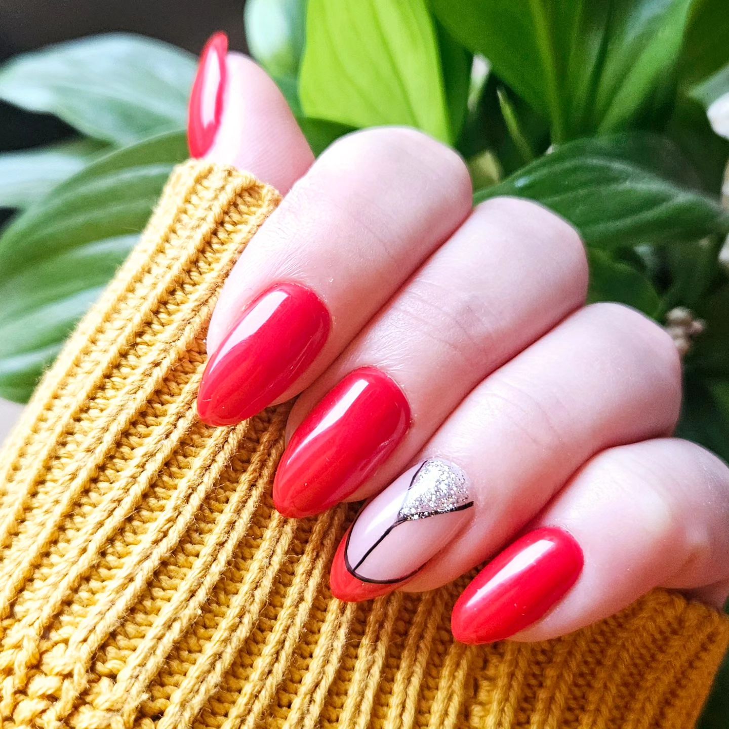 Sassy Red Almond Nails with Glittery Accent