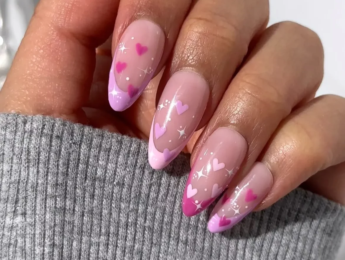 Love-inspired nails: pink hearts on a sheer base