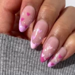 Love-inspired nails: pink hearts on a sheer base